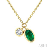 5x3 MM Oval Cut Emerald and 1/50 Ctw Bezel Set Round Cut Diamond Precious Pendant With Chain in 10K Yellow Gold